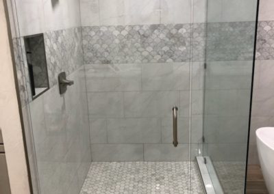 Glass shower with new tiles and backsplash.